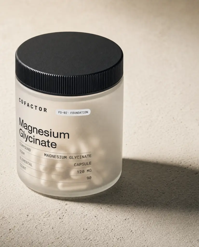 COFACTOR Magnesium Glycinate jar at a three-quarter angle, frosted glass with a matte black cap.