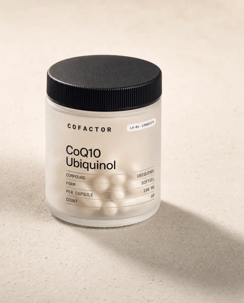 CoQ10 Ubiquinol jar at a three-quarter angle, frosted glass with a matte black cap.