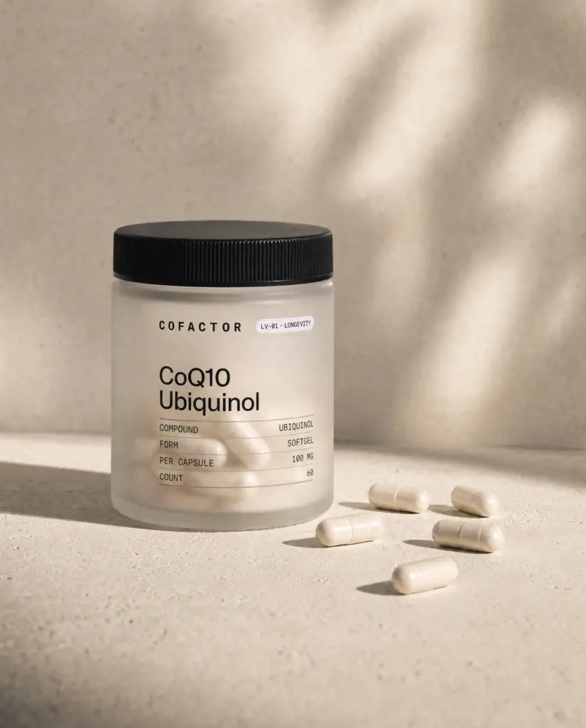 CoQ10 Ubiquinol jar with several softgels on the surface beside it.