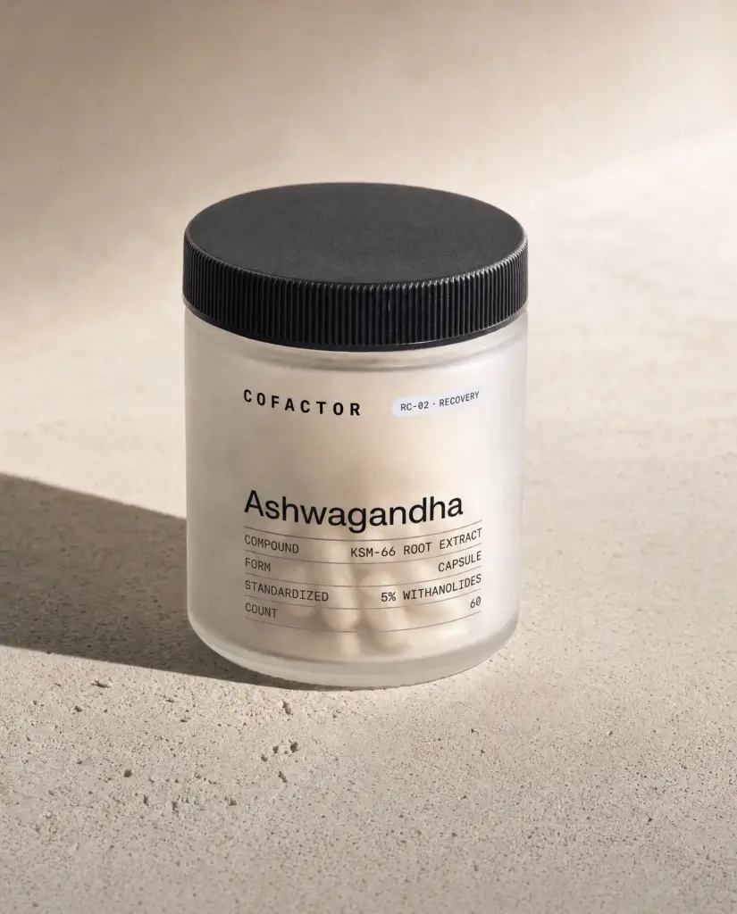 Ashwagandha jar at a three-quarter angle, frosted glass with a matte black cap.