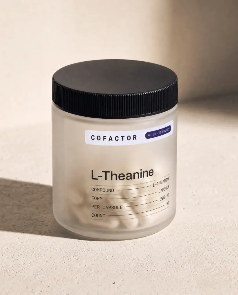 L-Theanine jar at a three-quarter angle, frosted glass with a matte black cap.